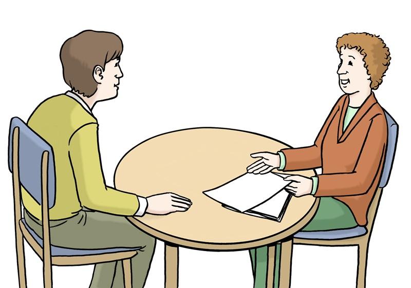 zwei Menschen am Tisch im Gespräch