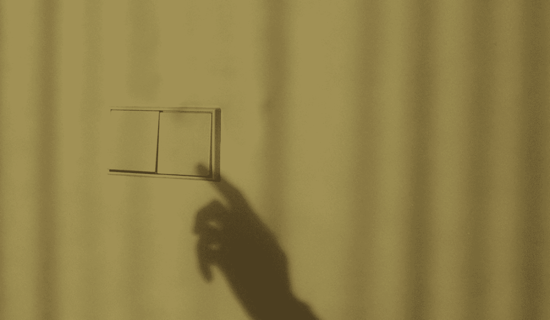 Schatten einer Hand betätigt Lichtschalter