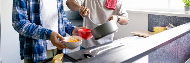 Zwei Männer kochen gemeinsam in einer Küche