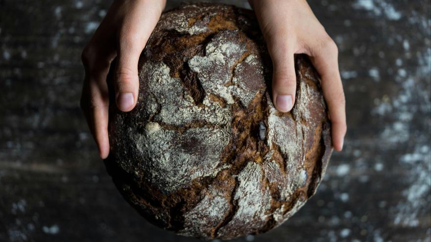 Ein Brot wird in zwei Händen gehalten