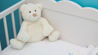 Babybett mit einem Teddybären